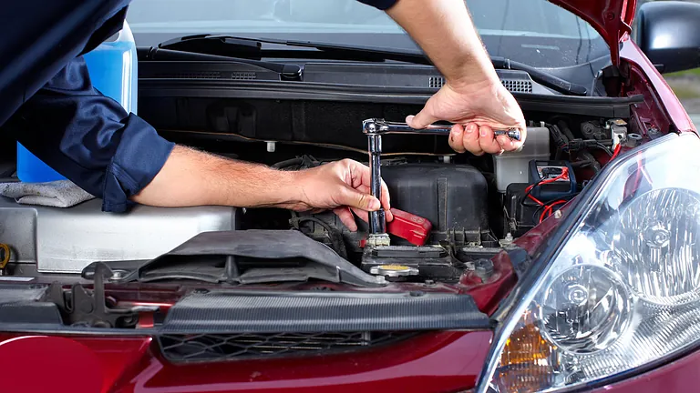 a mechanic working of a car engine